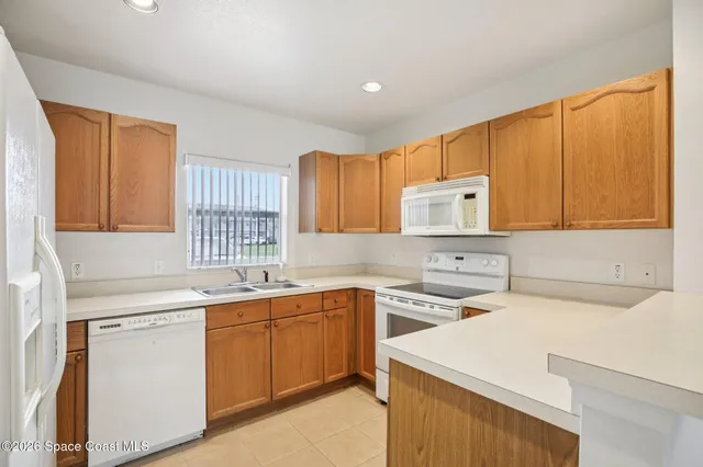 a kitchen with a sink a stove and cabinets