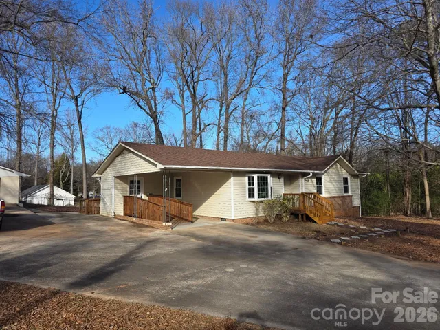 a view of a house with a yard covered in the road