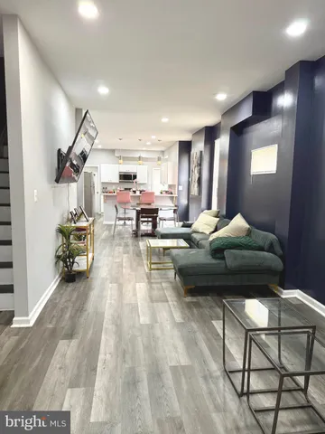 a living room with furniture and kitchen view