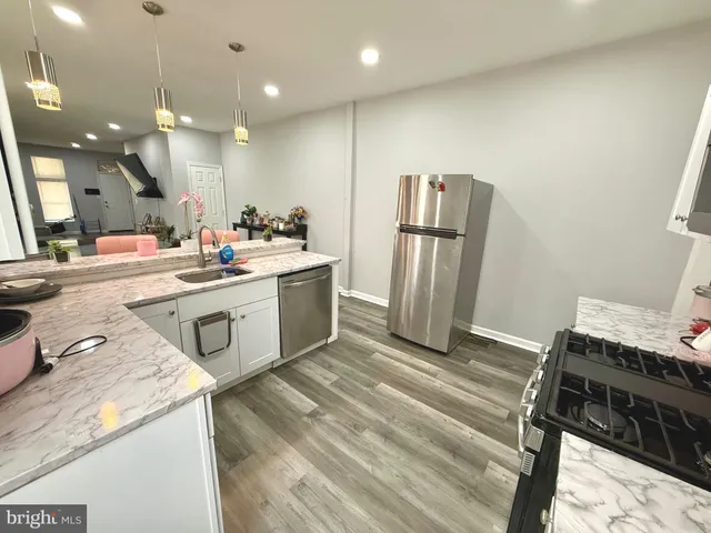 a kitchen with a sink stainless steel appliances and cabinets