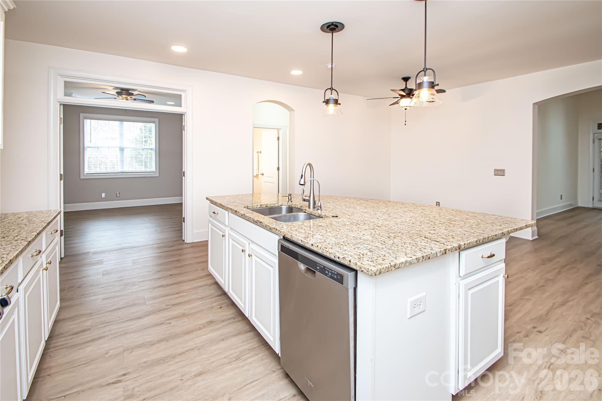 7900 Honey Fig Road Charlotte, NC 28277 - Photo 14 of 48 a large kitchen with kitchen island a wooden floor and a sink