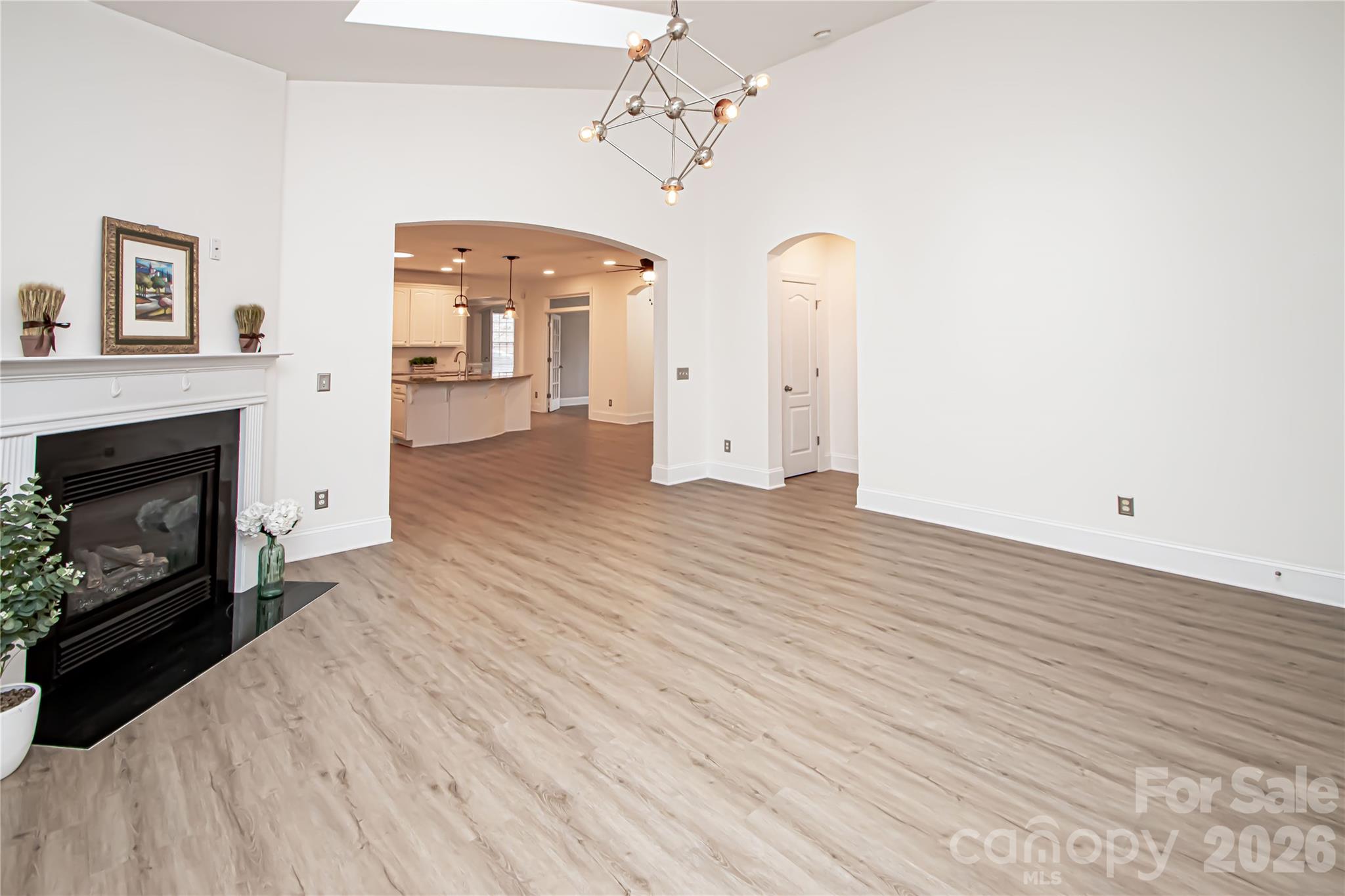 7900 Honey Fig Road Charlotte, NC 28277 - Photo 21 of 48 a view of a livingroom with wooden floor and a fireplace
