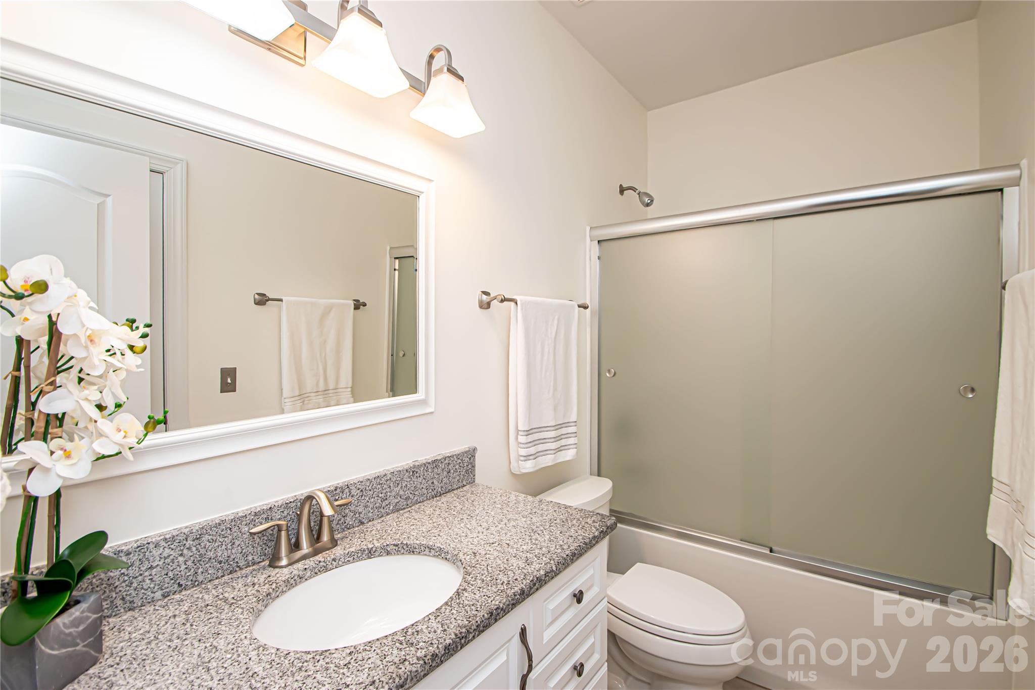 7900 Honey Fig Road Charlotte, NC 28277 - Photo 29 of 48 a bathroom with a granite countertop sink toilet and shower
