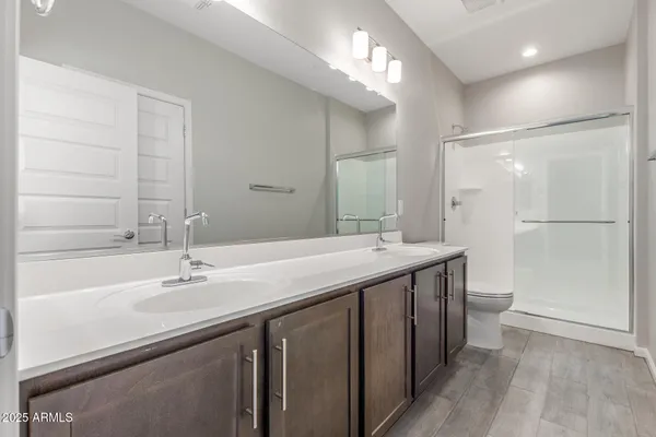 a bathroom with a double vanity sink mirror double and shower