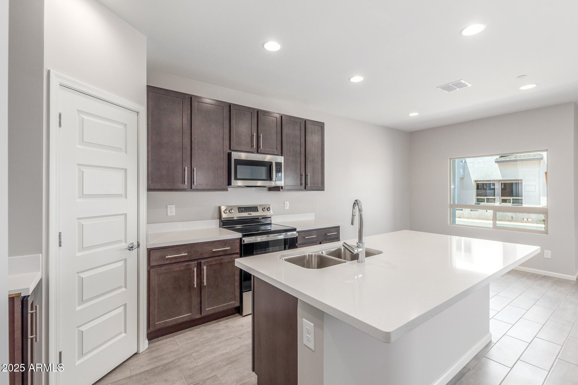 733 East Commonwealth Avenue, Unit 29 Chandler, AZ 85225 - Photo 6 of 37 a kitchen with kitchen island a sink appliances and cabinets