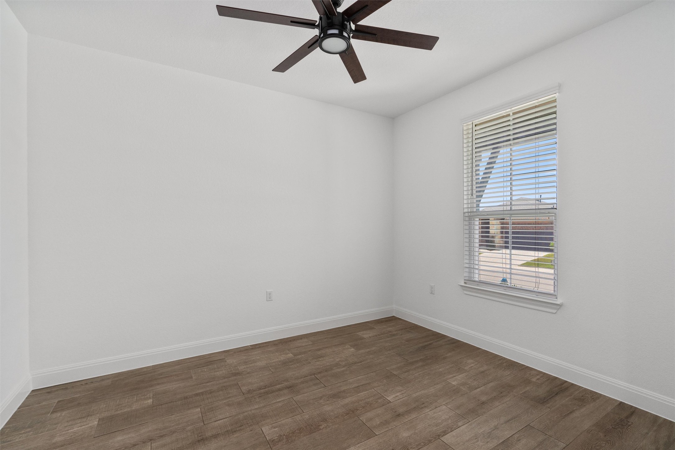 202 Spanish Star Street Georgetown, TX 78633 - Photo 5 of 32 a view of an empty room with wooden floor and a window
