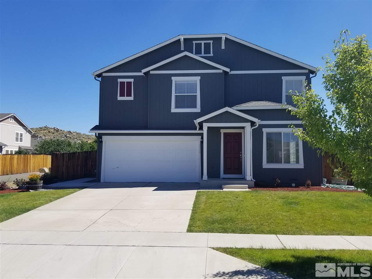 7740 Corso Street Reno, NV 89506 - Photo 1 of 1 a front view of a house with a yard and garage