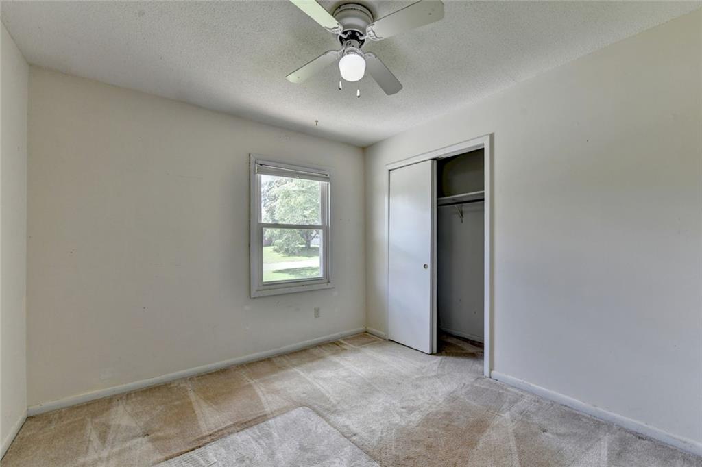 1577 Harbour Oaks Road Tucker, GA 30084 - Photo 41 of 58 an empty room with ceiling fan and window