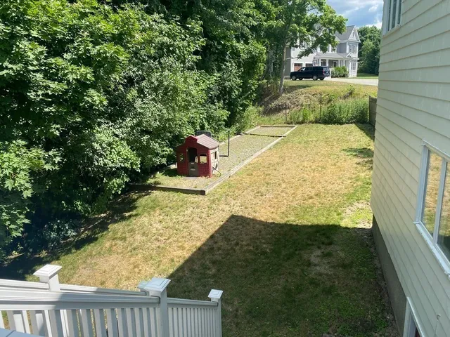 a view of a yard with wooden fence