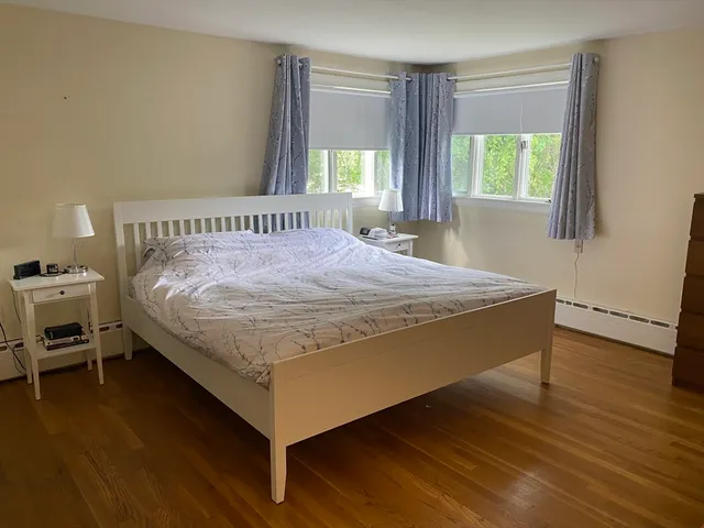 a bed sitting in a bedroom next to a window