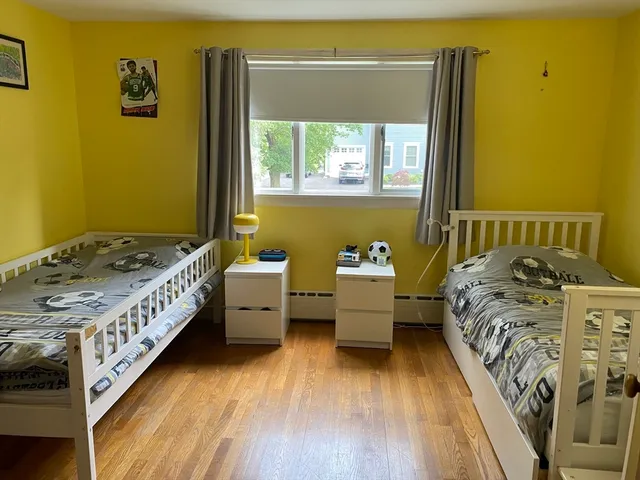 a bed room with a bed and a chair