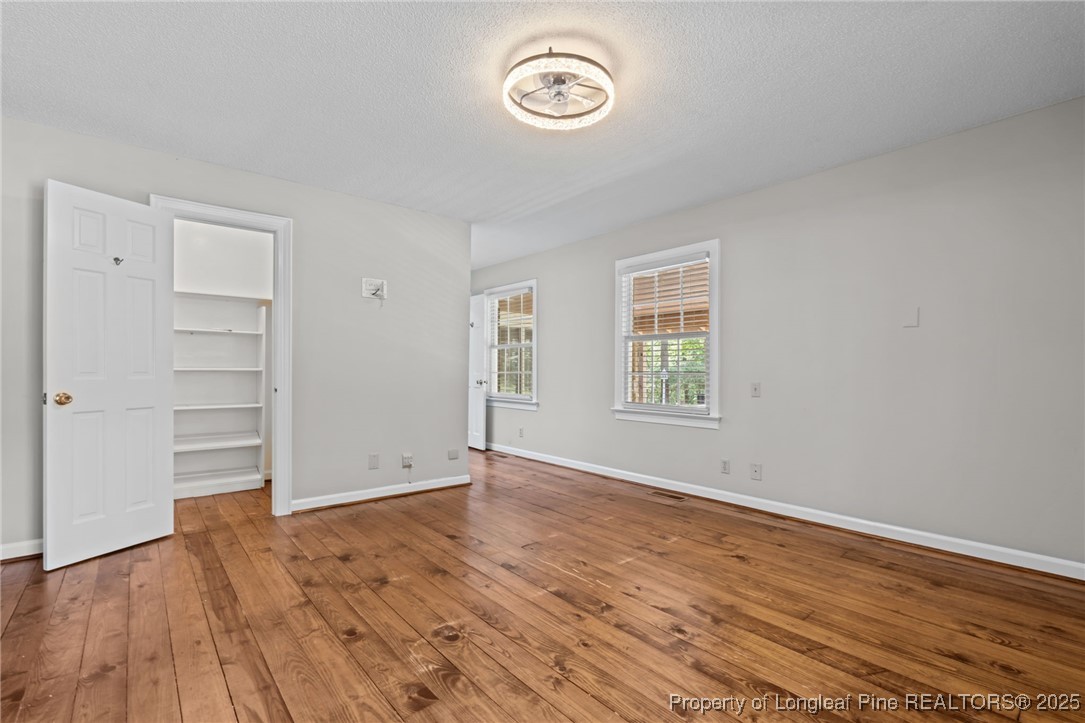 610 Maynard Lake Road Erwin, NC 28339 - Photo 17 of 49 an empty room with wooden floor closet and windows