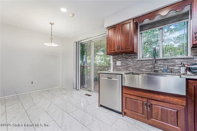 a kitchen with granite countertop a stove a sink and a granite counter tops