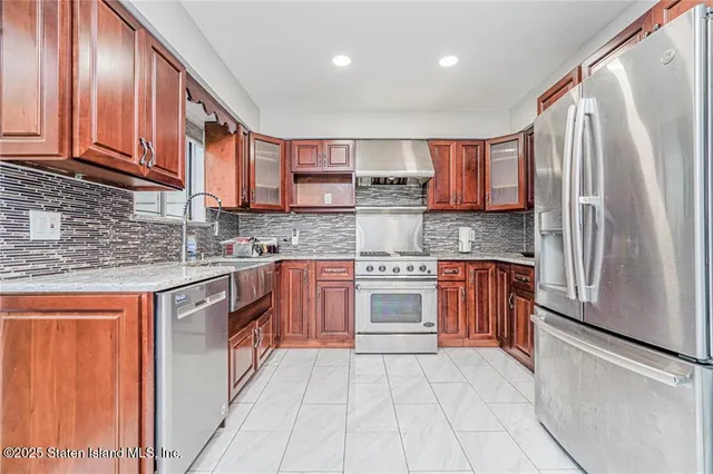 a kitchen with stainless steel appliances granite countertop a refrigerator sink and cabinets