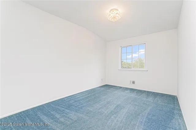 an empty room with a empty space and windows