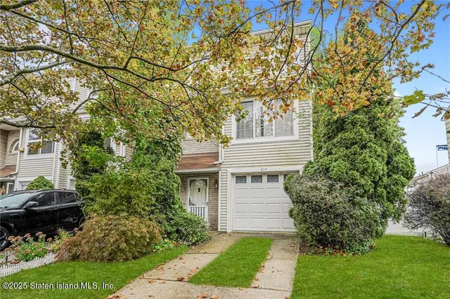 a front view of a house with a garden