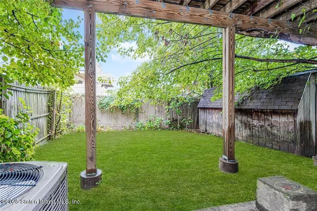a view of a chair and table in the garden