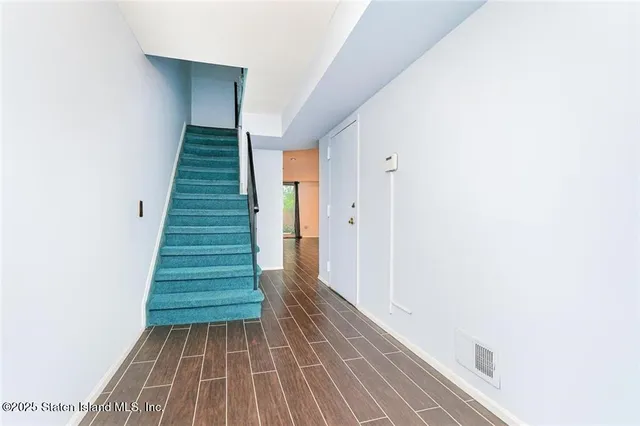 a view of a hallway with stairs