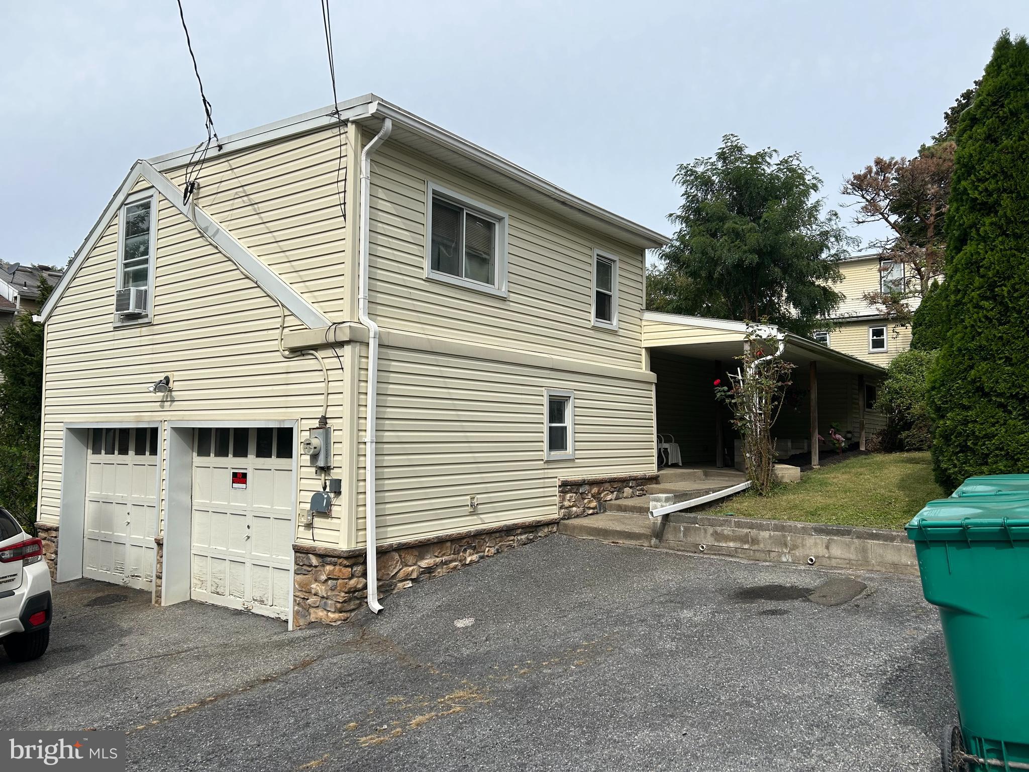 a view of a white house with a yard and garage