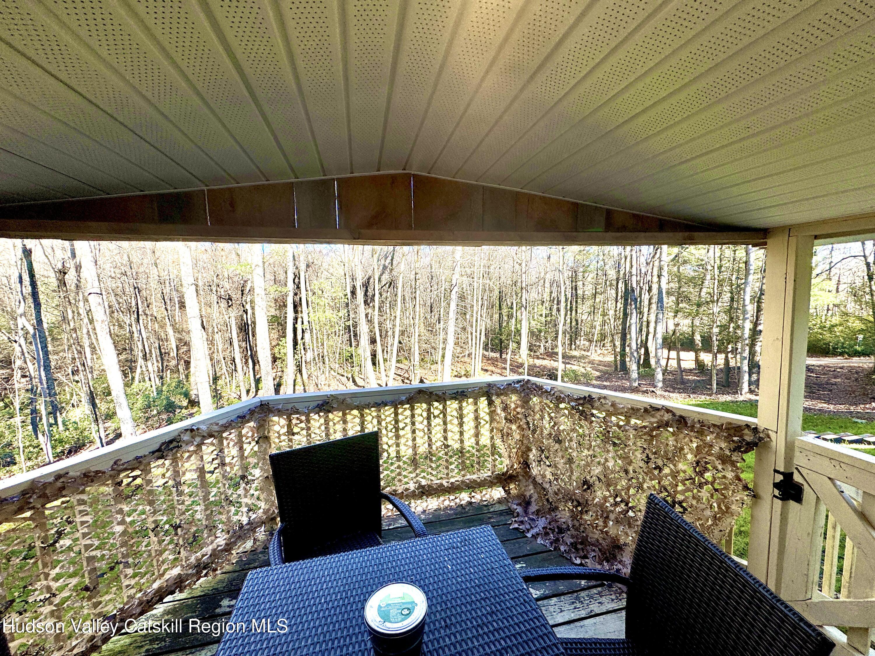 50 Harris Road Kerhonkson, NY 12446 - Photo 18 of 28 a view of a porch with furniture and wooden floor