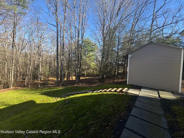 a view of house with outdoor space and garden