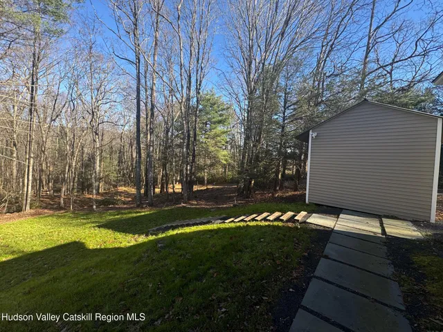 a view of house with outdoor space and garden