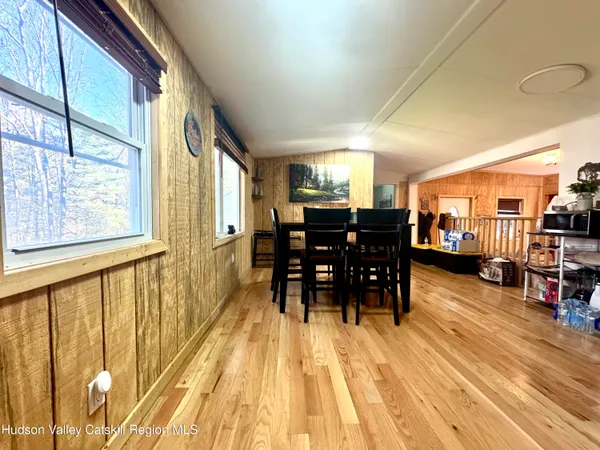 a dining room with furniture and wooden floor