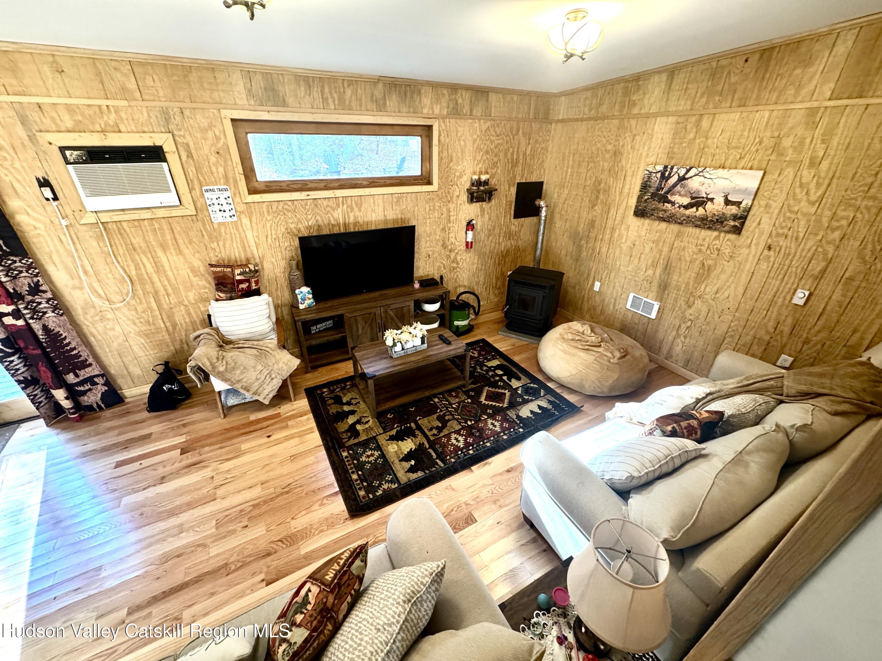 50 Harris Road Kerhonkson, NY 12446 - Photo 6 of 28 a living room with furniture and a fireplace