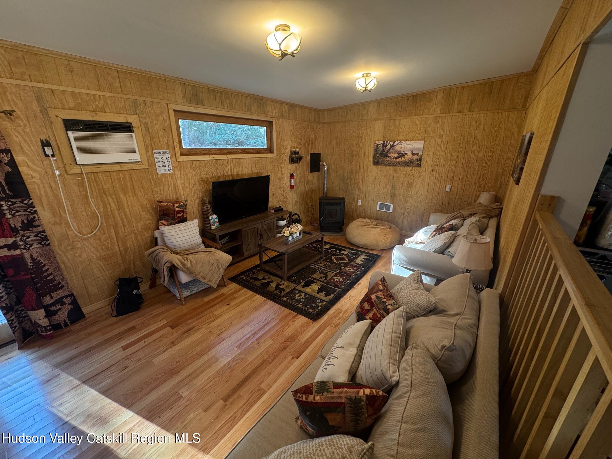 50 Harris Road Kerhonkson, NY 12446 - Photo 7 of 28 a living room with furniture and a fireplace