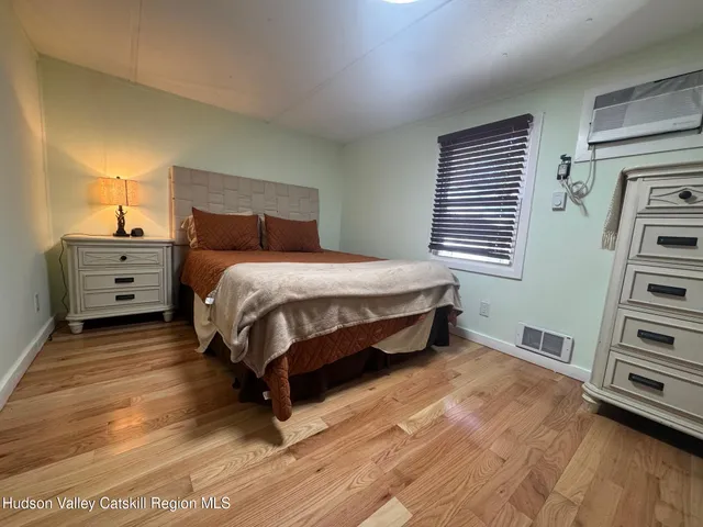 a bed sitting in a bedroom next to a window