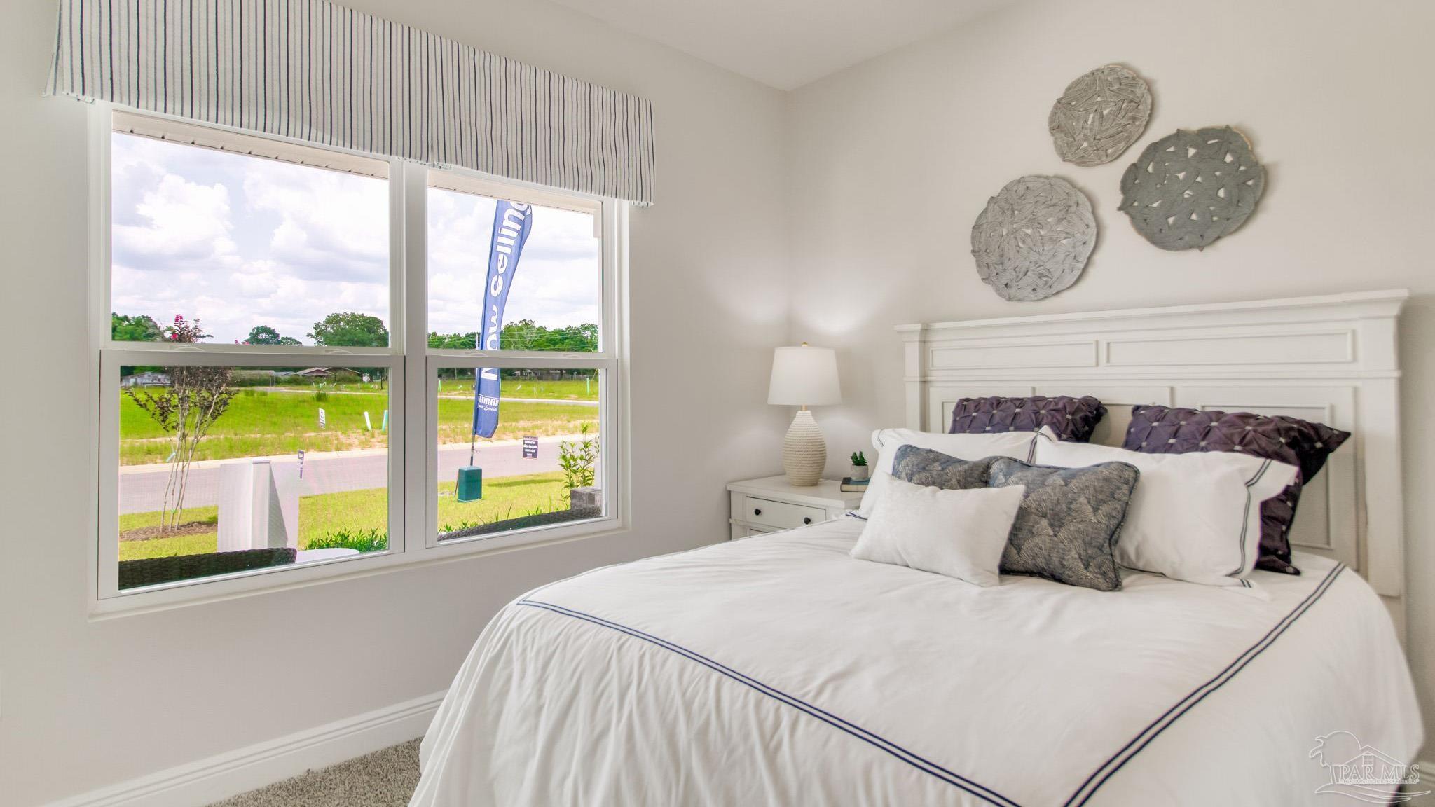 108 Albatross Street Cantonment, FL 32533 - Photo 27 of 35 a bedroom with a bed and a window