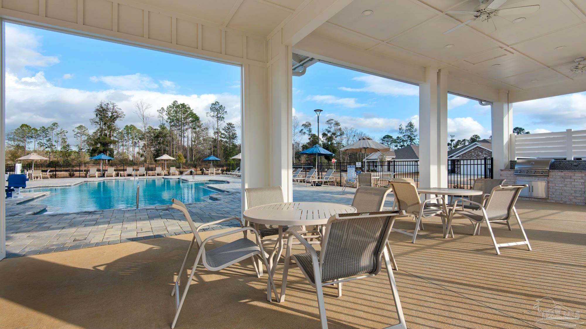 108 Albatross Street Cantonment, FL 32533 - Photo 35 of 35 a view of a patio with dining table and chairs