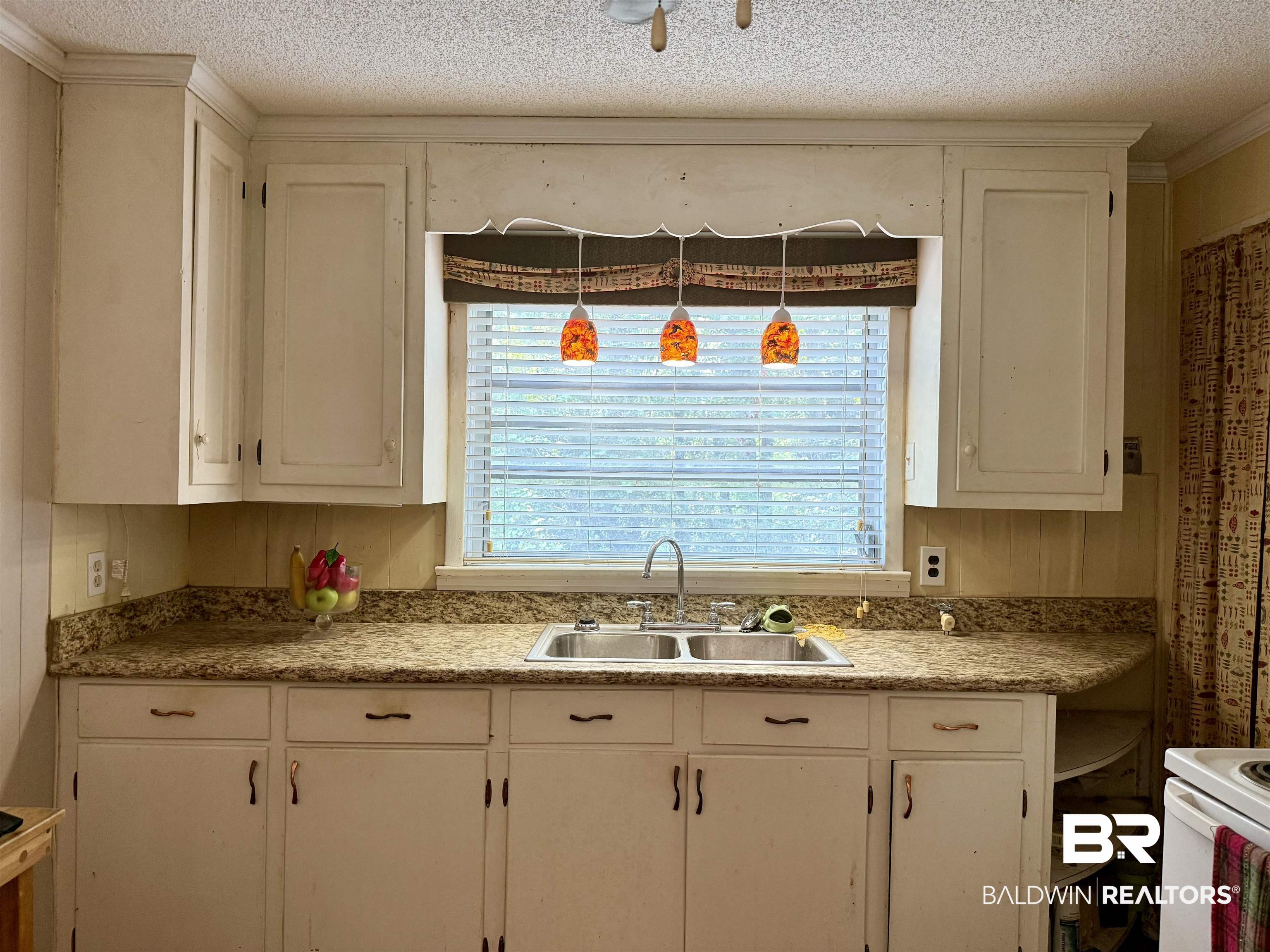 778 Buddy Lake Road Brewton, AL 36426 - Photo 5 of 7 Kitchen featuring light countertops, a textured ceiling, white cabinets, open shelves, and ornamental molding