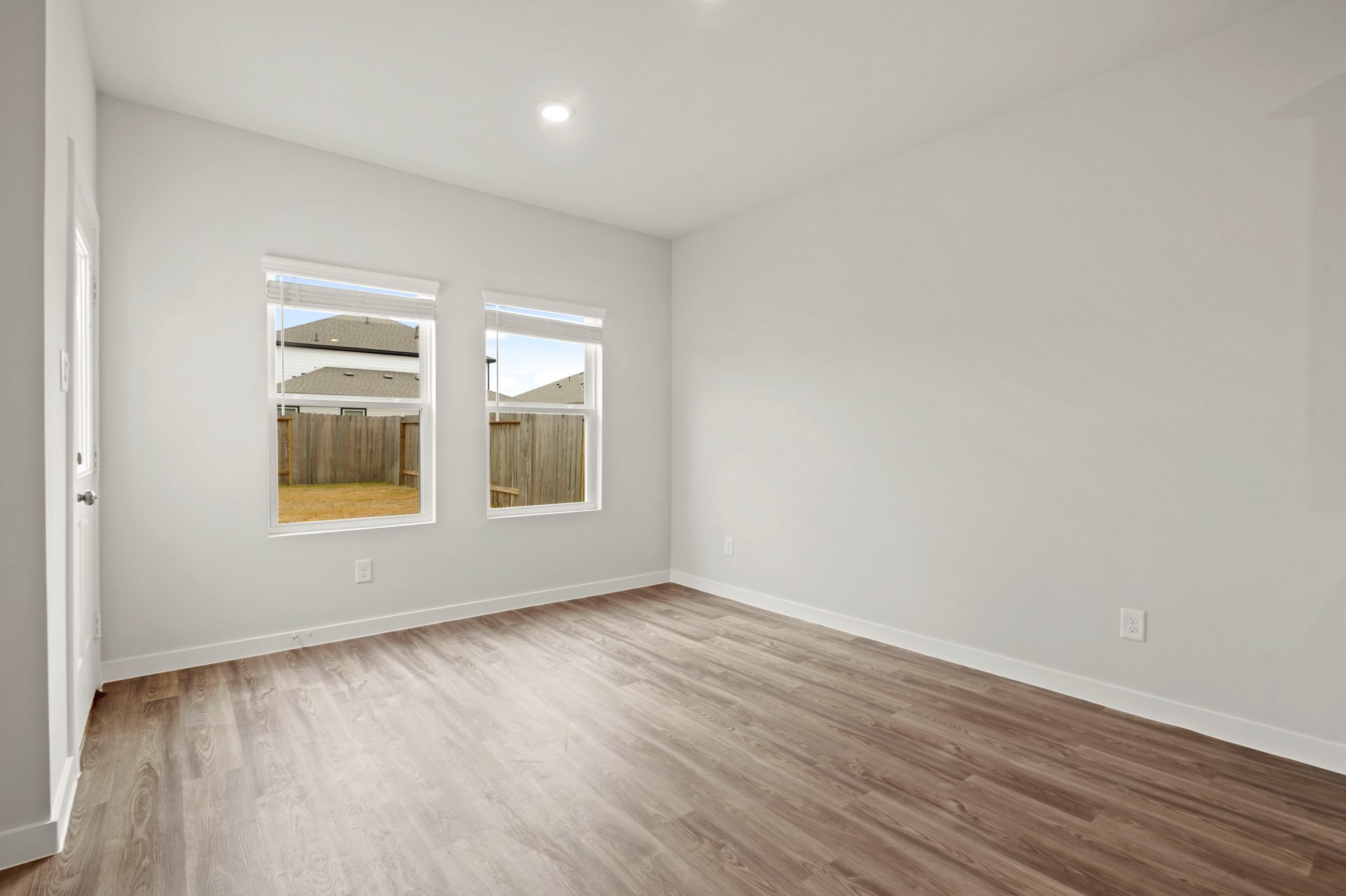 527 Shoreview Drive Conroe, TX 77303 - Photo 9 of 27 a view of an empty room with wooden floor and a window