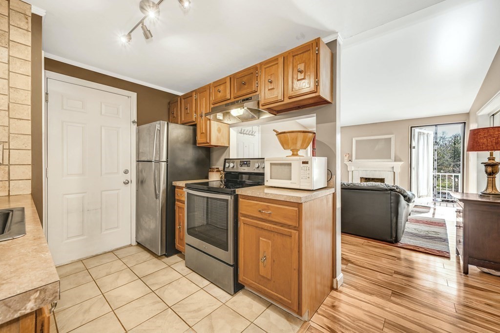 4 Walden Drive, Unit 19 Natick, MA 01760 - Photo 13 of 42 a kitchen with stainless steel appliances granite countertop a refrigerator a stove a sink dishwasher and a refrigerator with wooden floor