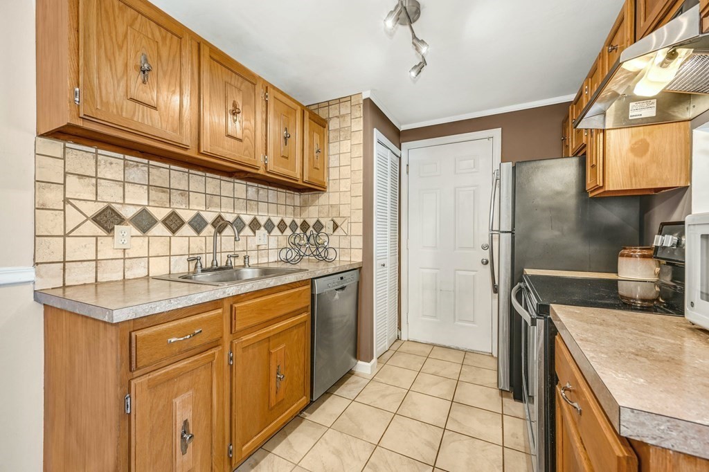 4 Walden Drive, Unit 19 Natick, MA 01760 - Photo 14 of 42 a kitchen with stainless steel appliances granite countertop a sink stove and refrigerator