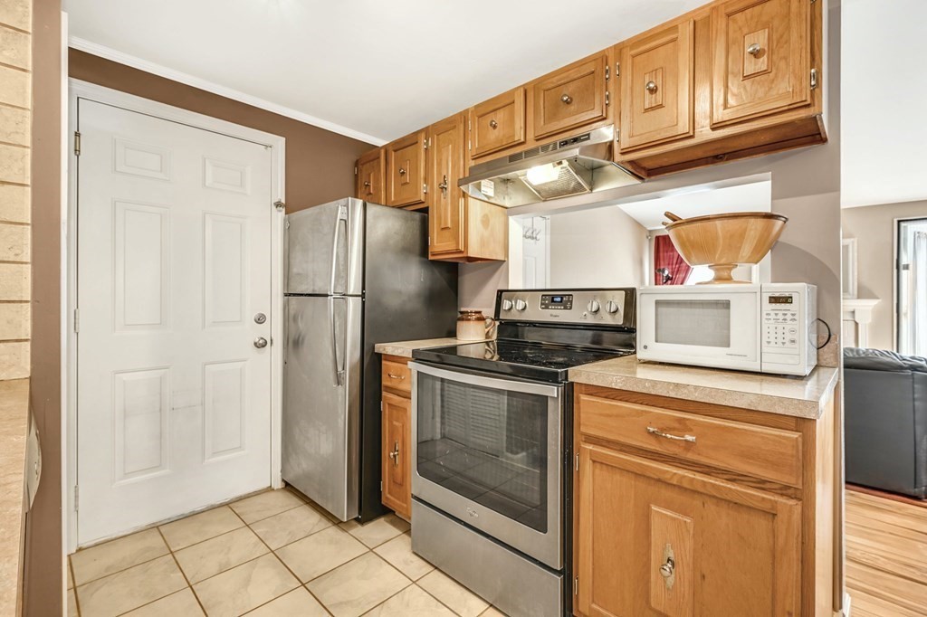 4 Walden Drive, Unit 19 Natick, MA 01760 - Photo 15 of 42 a kitchen with stainless steel appliances granite countertop a refrigerator and a stove