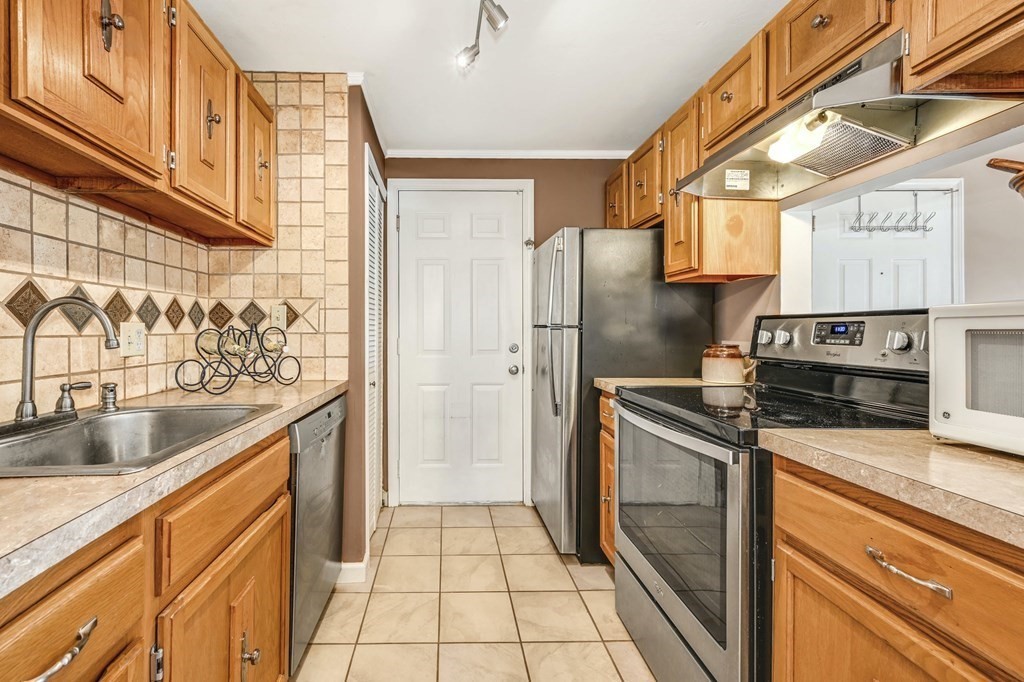 4 Walden Drive, Unit 19 Natick, MA 01760 - Photo 16 of 42 a kitchen with stainless steel appliances granite countertop a sink a stove and a refrigerator