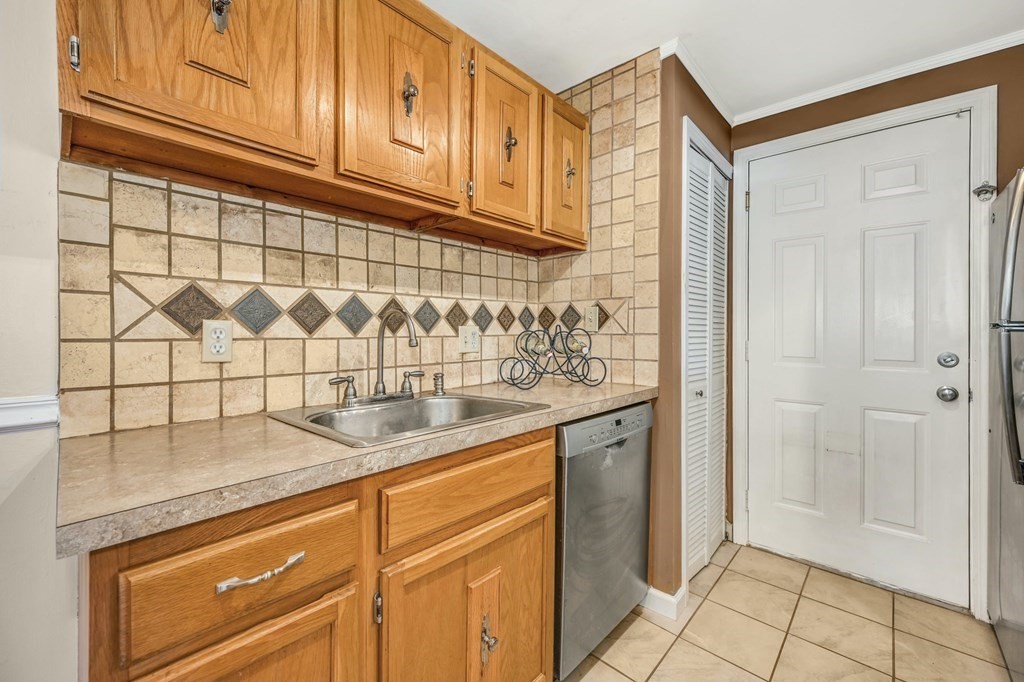 4 Walden Drive, Unit 19 Natick, MA 01760 - Photo 17 of 42 a kitchen with stainless steel appliances granite countertop a sink and cabinets