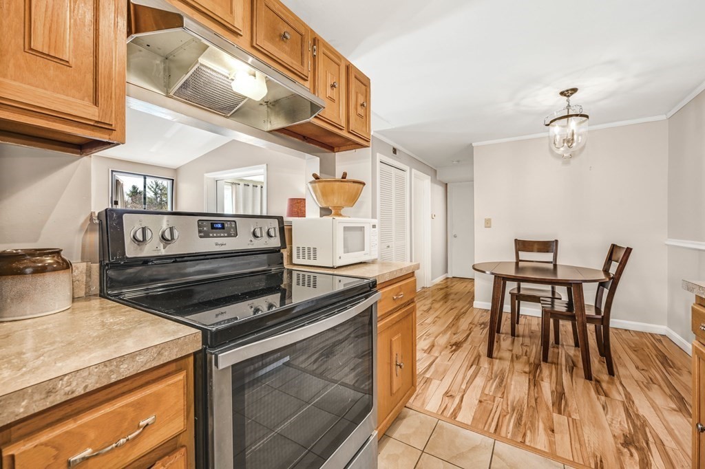 4 Walden Drive, Unit 19 Natick, MA 01760 - Photo 18 of 42 a kitchen view of a dining table chairs and stove