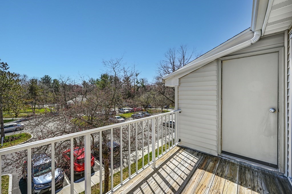 4 Walden Drive, Unit 19 Natick, MA 01760 - Photo 31 of 42 a view of a balcony with wooden fence and floor