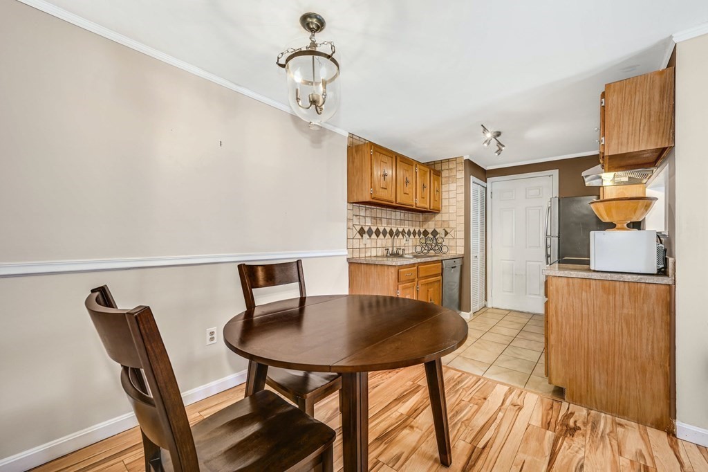 4 Walden Drive, Unit 19 Natick, MA 01760 - Photo 10 of 42 a kitchen with stainless steel appliances kitchen island granite countertop a dining table chairs and a refrigerator