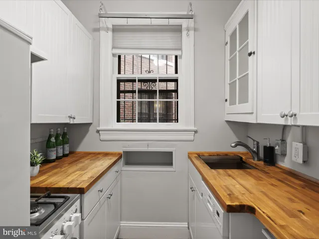 a kitchen with a sink and cabinets