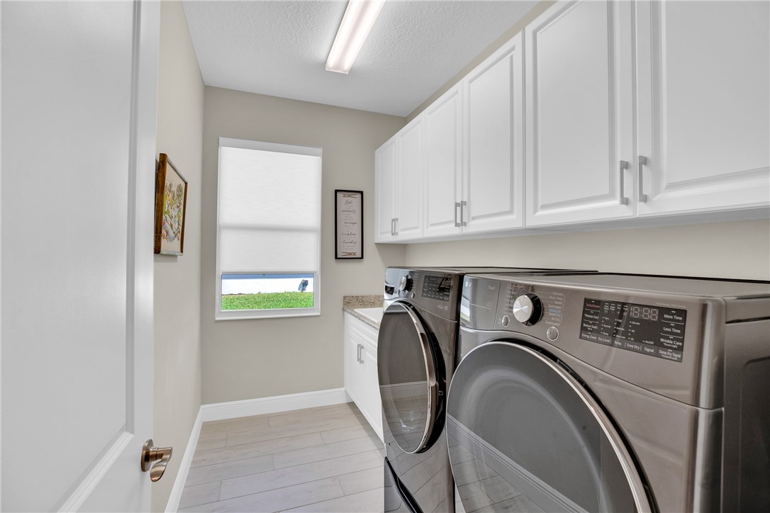 105 Night Hawk Way Sebastian, FL 32958 - Photo 28 of 36 a utility room with dryer and washer