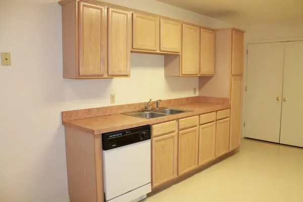 a kitchen with stainless steel appliances granite countertop white cabinets and a sink