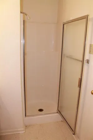 a bathroom with a glass shower door