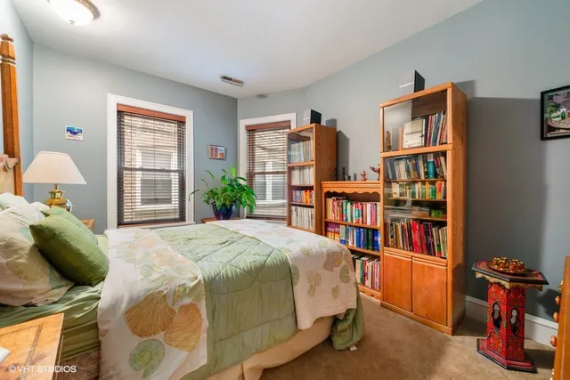 a bedroom with a bed furniture and a book shelf