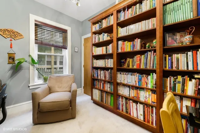 a living room with a book shelf and a book shelf