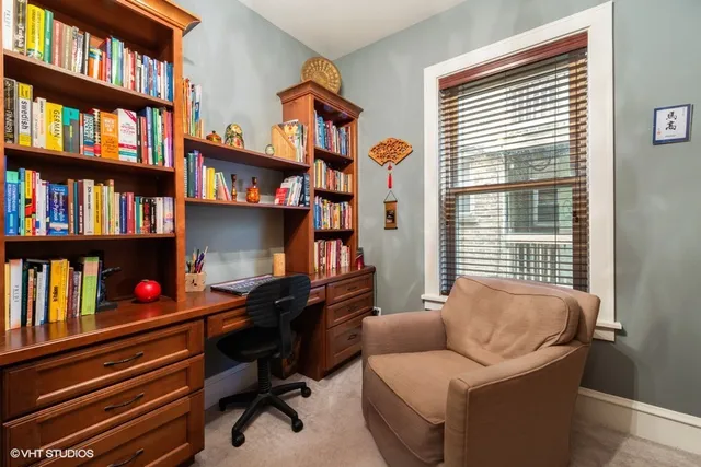 a livingroom with a book shelf and a window