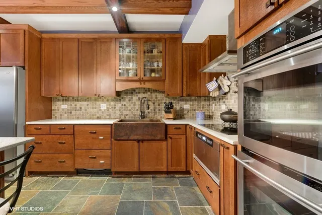 a kitchen with a wooden cabinets and a stove top oven